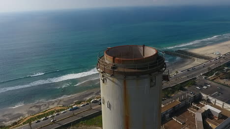 Cinematic-drone-shot-of-smokestack-at-the-NRG-Encina-Power-Plant-on-the-coast-of-Carlsbad,-CA