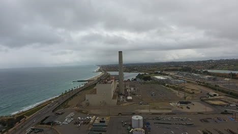 Cinematic-drone-shot-of-smokestack-at-the-NRG-Encina-Power-Plant-on-the-coast-of-Carlsbad,-CA