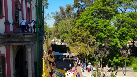 Giant-puzzle-at-the-Iztapalapa-Cathedral,-Señor-de-la-Cuevita-flower-montage-on-a-sunny-day-in-CDMX,-Mexico