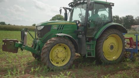 Follow-Shot-Of-John-Deere-Tractor-On-Farm-In-Vendee,-France