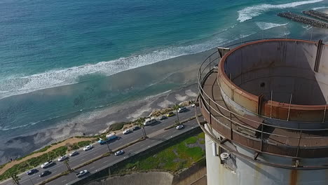 Cinematic-drone-shot-of-smokestack-at-the-NRG-Encina-Power-Plant-on-the-coast-of-Carlsbad,-CA