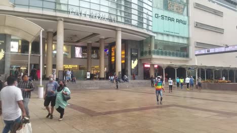 People-Wearing-Masks-While-Strolling-At-The-Palladium-Mall-In-Mumbai,-India-During-Coronavirus-Pandemic---wide-shot