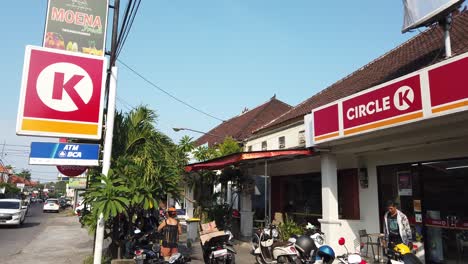 Circle-K-Shop-Entrance-in-Bali-Indonesia,-Mini-Market-Logo-Outdoors-Convenience-Store,-Scooters-and-Motorbikes,-Establishing-Shot-at-Daylight