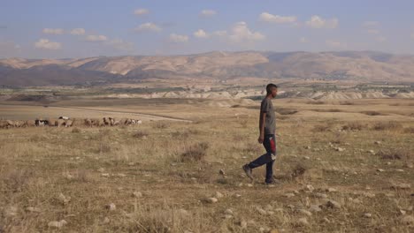 Silhouette-Of-An-Ethnic-Dark-Skinned-Man-Walking-Over-dry-field