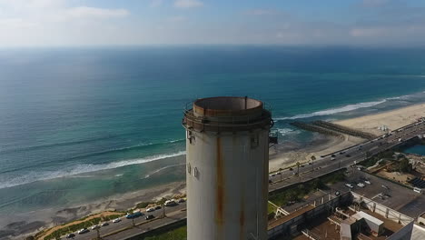 Cinematic-drone-shot-of-smokestack-at-the-NRG-Encina-Power-Plant-on-the-coast-of-Carlsbad,-CA