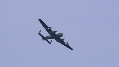 Slow-motion-view-of-Avro-Lancaster-heavy-bomber-airplane-during-the-day-in-the-blue-sky