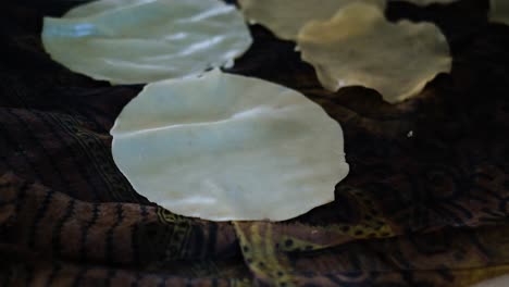 close-up-scene-in-which-an-Indian-woman-is-hanging-papadam-to-dry