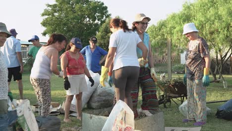 Group-of-neighbors-preparing-a-pile-of-compost-in-a-back-yard