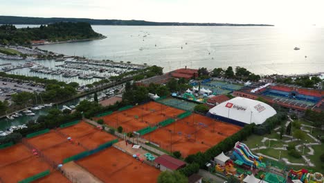 Drone-aerial-fast-forward-flying-seaside-coastal-view-of-Portoroz-ATP-Challenger-Slovenia-Open-tennis-grounds