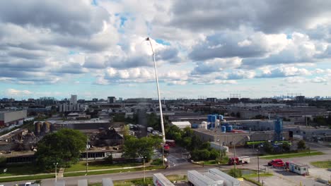 Aerial-view-of-firefighters-cleanup-an-Industrial-site-Aftermath-Massive-Fire,-Toronto