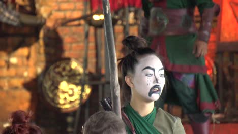 Masked-Actress-in-Traditional-Thai-Costume-During-Open-Air-Play-in-Ancient-Siam,-Erawan-National-Park,-Thailand,-Slow-Motion