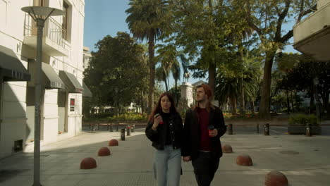 Young-couple-walking-through-a-corridor-in-an-old-town