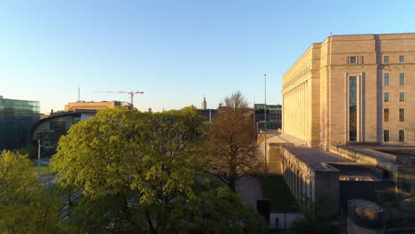 Aerial,-rising,-drone-shot-of-the-Parliament-house-in-Toolo,-Helsinki,-Finland,-sunny,-summer-morning-sunrise,-in-Finland