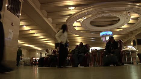 People-Walking-Through-Grand-Central-Station-Past-People-Sitting-On-Comfy-Seats