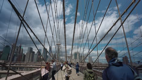 People-Walking-Along-Walkway-On-Brooklyn-Bridge