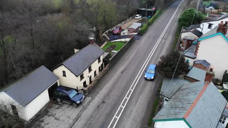 Aerial-of-English-village-in-Devon,-Slowly-Revealing-the-Countrside