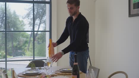 Man-is-closing-in-to-the-table-and-pouring-drink-in-glass