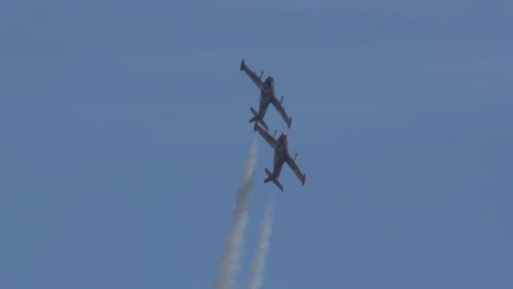 Two-BAC-Strikemasters-maneuvering-close-to-each-other-mid-air-in-slow-motion,-Bournemouth,-England