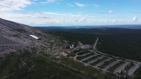 Aerial-view-around-the-Y1-Ski-shop-and-restaurant-area,-under-the-bike-trail-slopes-of-Yllastunturi-fell,-in-Yllas,-Kolari,-Lapland,-Finland---orbit,-drone-shot