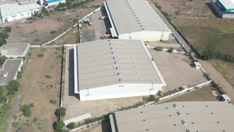 aerial-drone-shot-drone-top-angle-view-where-a-large-industrial-is-visible-and-many-trucks-are-being-loaded