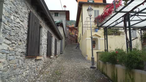 Man-Dressed-With-Very-Colourful-Clothes-Walks-in-the-Street-of-Varenna-Town