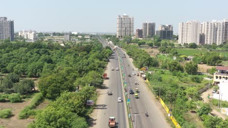 aerial-drone-shot-The-drone-camera-is-moving-towards-the-front-and-there-is-a-large-view-of-the-surrounding-area-with-lots-of-fields-and-tall-trees