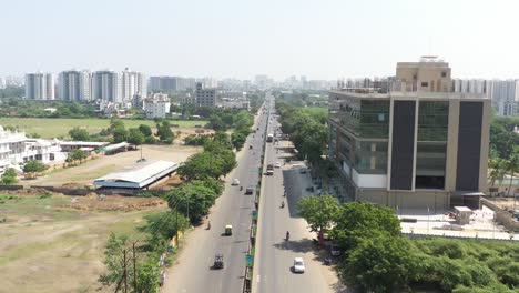 aerial-drone-shot-The-drone-camera-is-moving-towards-the-front-where-a-commercial-building-is-visible-where-many-cars-and-bikes-are-parked