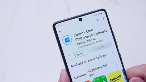A-close-up-of-an-individual-downloading-an-application-and-installing-it-in-a-mobile-phone