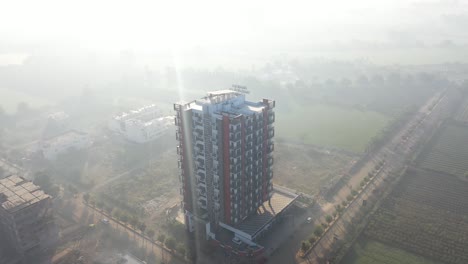 aerial-drone-shot-The-drone-is-heading-towards-Cameroon-where-the-sun's-rays-are-passing-over-the-building-and-the-building-is-looking-very-beautiful-and-there-are-large-fields-around