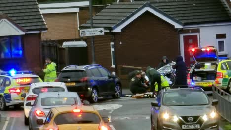 Police-and-ambulance-first-aid-assistance-at-Bicycle-collision-road-traffic-accident