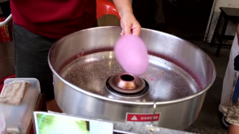 An-unrecognizable-person-preparing-cotton-candy