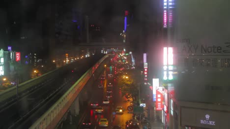 Focus-pull-from-water-drops-on-window-to-Taipei-traffic-scene-with-cars-at-night