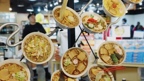 Slow-motion-pan-over-many-Ramen-Bowls-with-Different-Styles-Across-Japan-at-Yokohama-Ramen-Museum