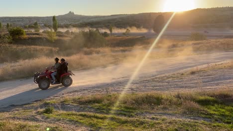 pov-shot-many-tourists-riding-bikes-sun-rays-falling-behind-mountains