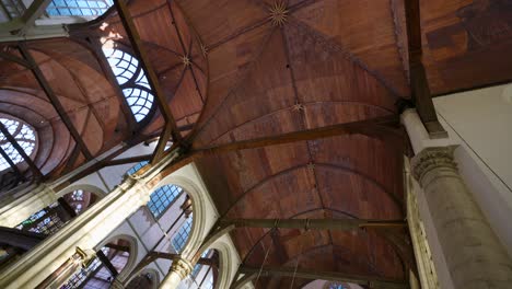 Looking-up-at-wooden-ceiling-of-famous-Old-Church,-a-tourism-landmark-in-Amsterdam