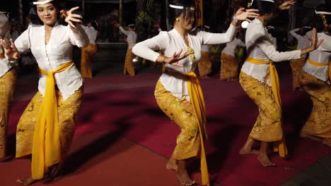 Balinese-woman-performing-ancient-ritual-religious-dance-wearing-traditional-clothing-in-the-island-of-gods,-touristic-spot-in-south-east-asia