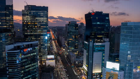 Sunset-Sky-Over-Towering-Gangnam-Skyscrapers-and-Seocho-daero-Road-Car-Traffic---Aerial-Timelapse