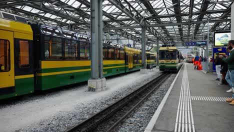 Tourist-wait-for-train-to-arrive-at-Lauterbrunnen-railway-station,-Switzerland