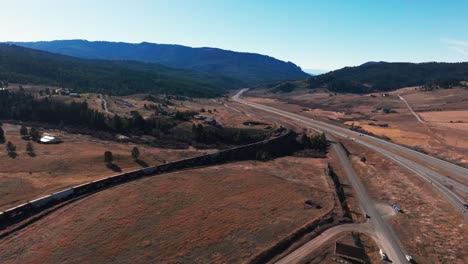 Drone-aerial-view-of-a-BSNF-Railway-Train-traveling-through-Montana