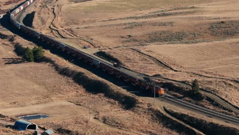 Close-up-drone-shot-of-a-BNSF-Train-outside-of-Bozeman,-Montana