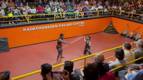 pov-shot-Two-people-are-playing-lathibaji-in-the-arena-New-Foreigner-people-are-watching-lathibaj