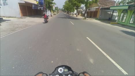 Pov-of-a-motorbike-rider-passing-by-in-the-morning-in-the-city-of-Blora,-Central-Java,-Indonesia