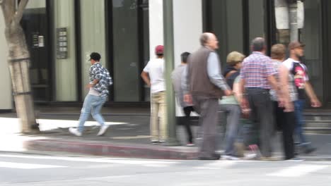 people-cross-street-in-busy-downtown-area