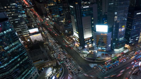 Hiperlapso-De-Tráfico-Nocturno-De-Vehículos-En-El-Cruce-De-La-Estación-De-Gangnam-En-Seúl-En-Invierno---Aéreo