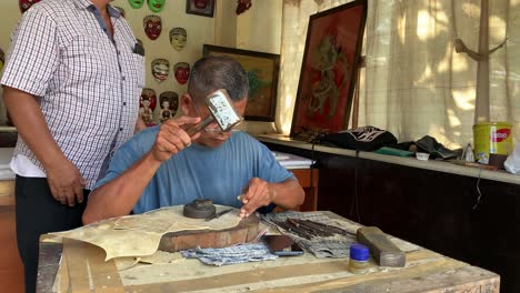 Yogyakarta,-Indonesia---Dec-16,-2023-:-Indonesian-man-making-carving-wayang-shadow-puppet