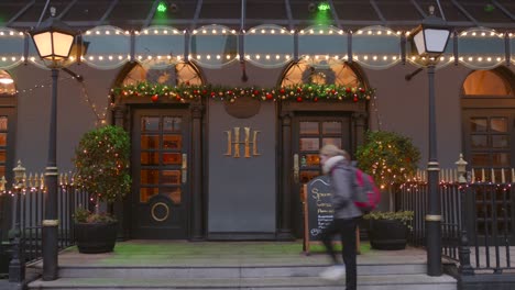 Shot-of-a-female-tourist-entering-the-Harcourt-Hotel-in-Dublin,-Ireland-during-evening-time