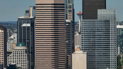 Aerial-shot-of-the-Space-Needle-peaking-through-downtown-skyscrapers-in-Seattle