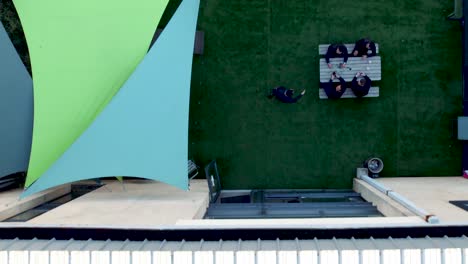 slow-motion-Top-down-shot-of-a-businessman-shaking-his-clients-hands-in-a-garden