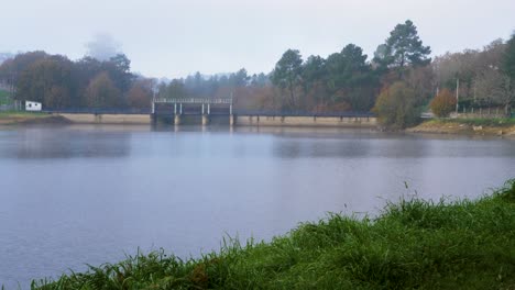 Hydraulic-gates-of-the-Cachamuiña-reservoir-on-a-cloudy-day-surrounded-by-trees-in-winter
