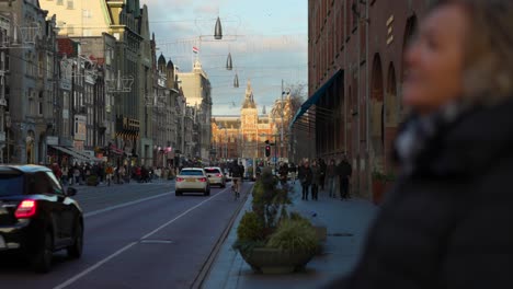 Pedestrians-walking-along-busy-central-street-in-Amsterdam,-Netherlands